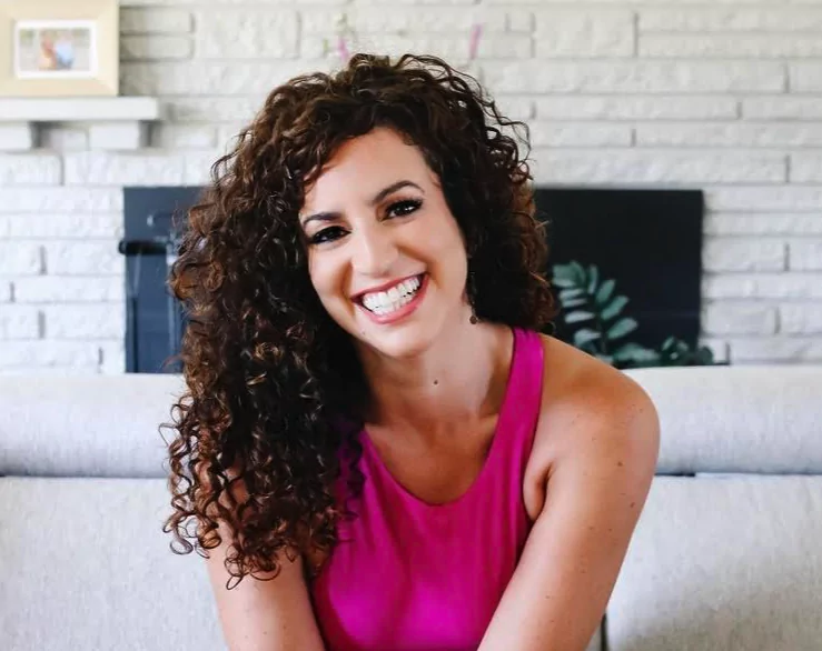 A smiling lady in a pink top