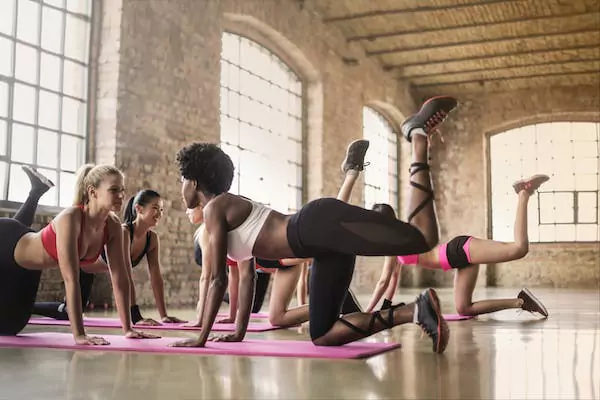 A group of people doing yoga together in a hall