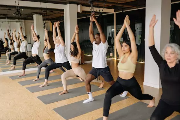 A group of people doing yoga together in a studio.