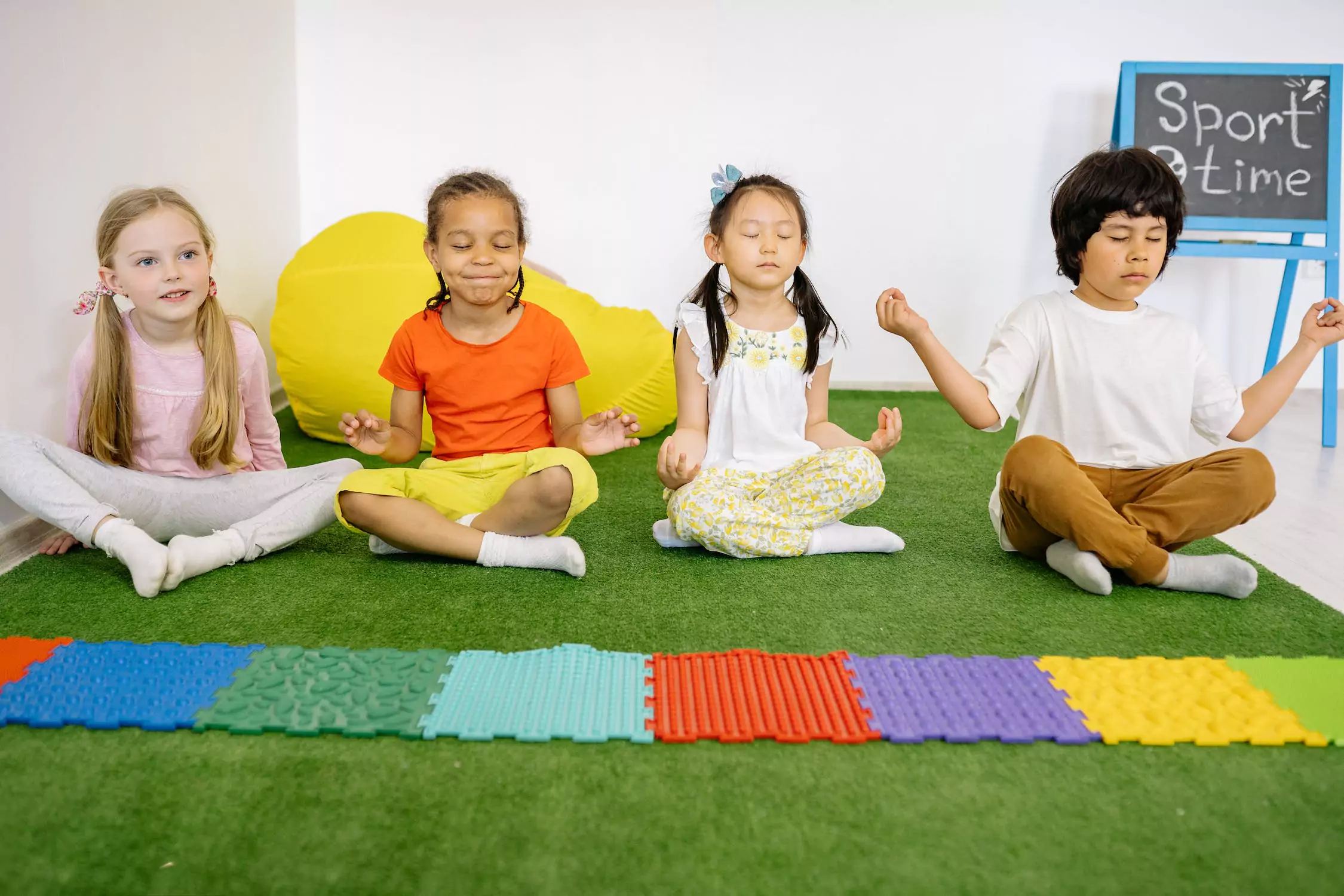 Four kids meditating together.