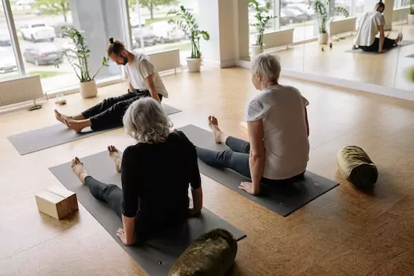 Three people meditating together.