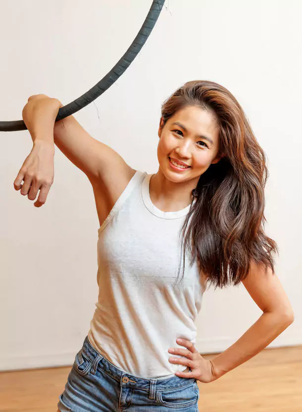 A smiling lady in a white top